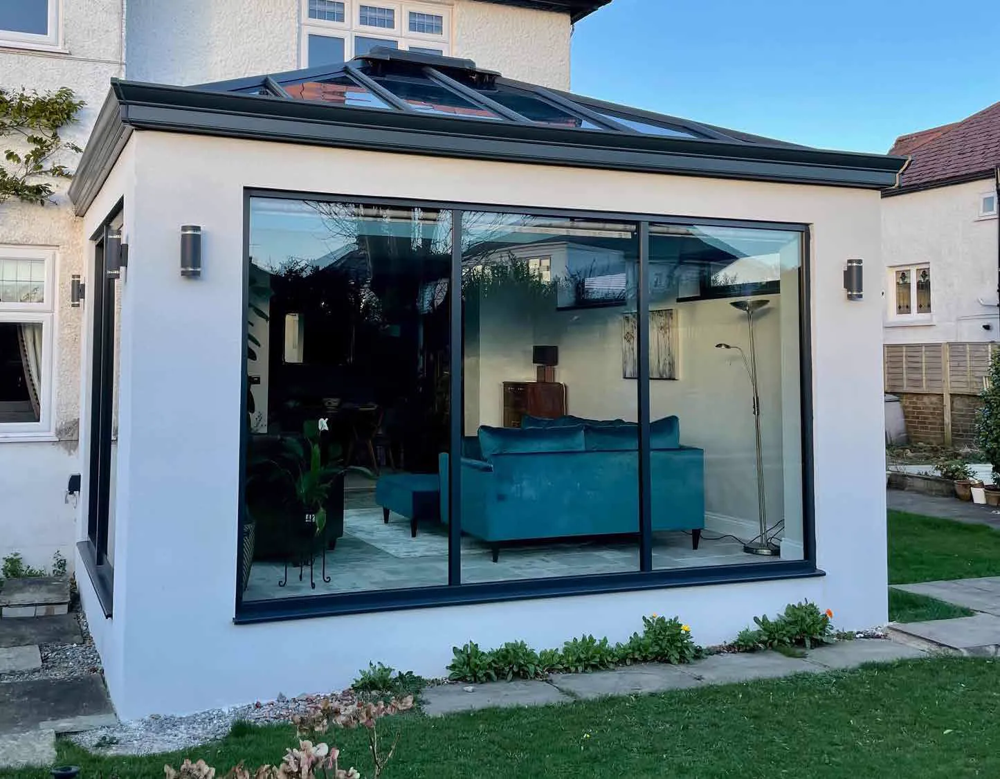 Glazed garden room with a roof lantern and dark frames