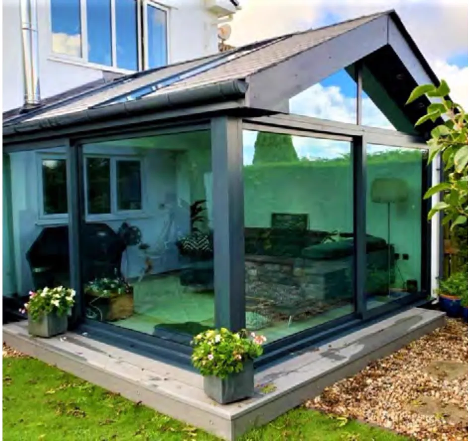 Garden room with broad glazing, a solid roof border and central roof glazing