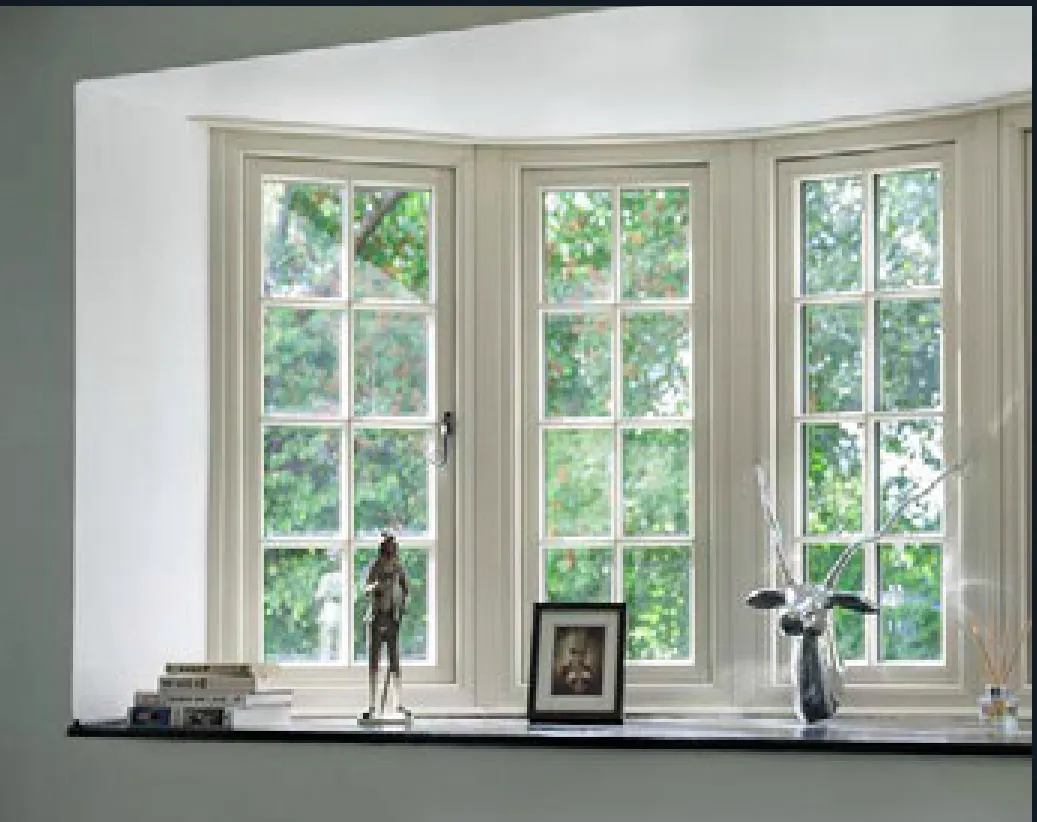 White window with glazing bars and framed photographs on the sill