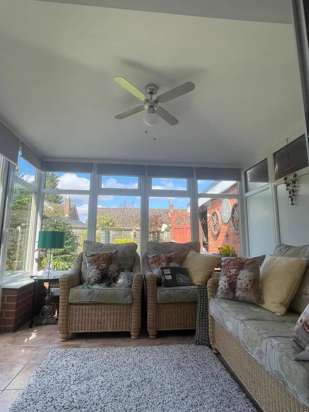 Furnished conservatory with white frames, seating and a finished ceiling