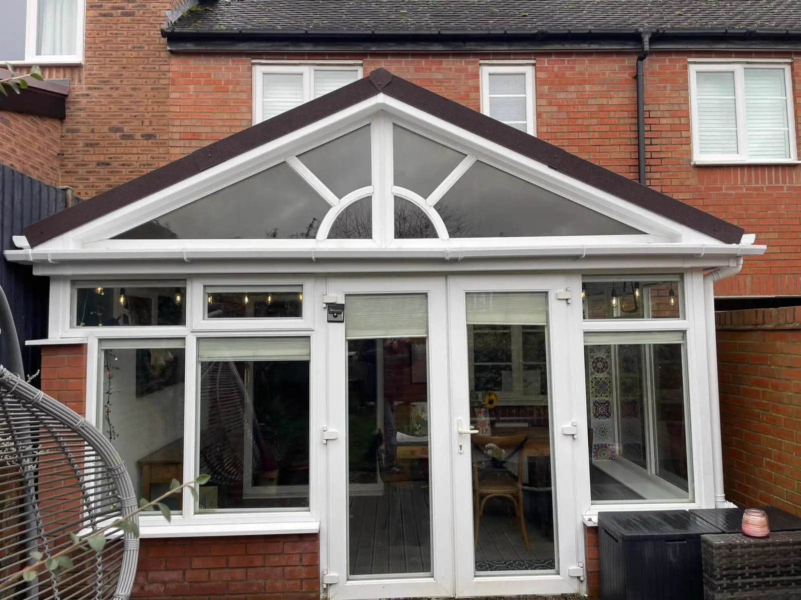 White-framed gable conservatory with glazed doors